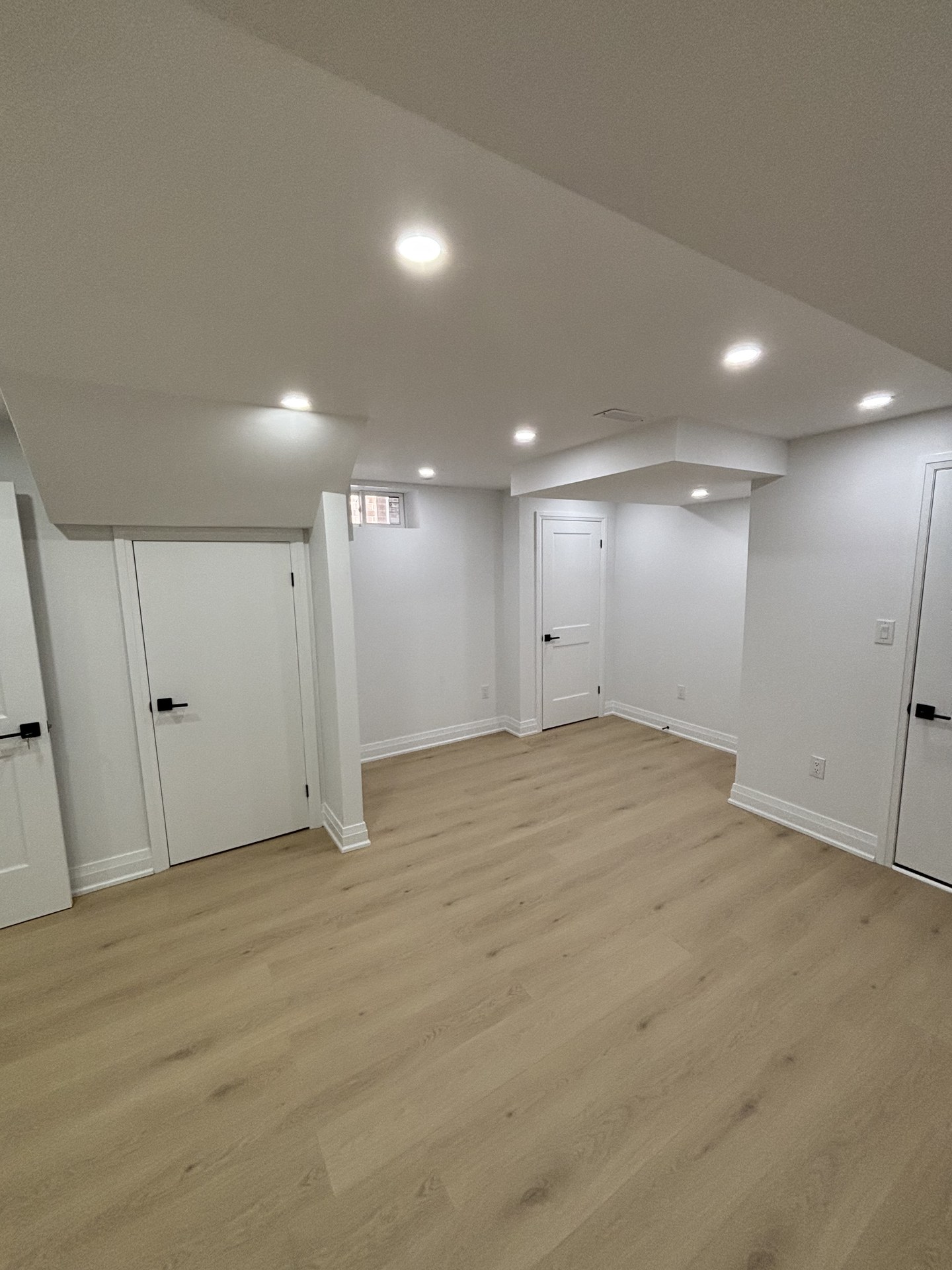 Open concept finished basement design by WEIVA Homes