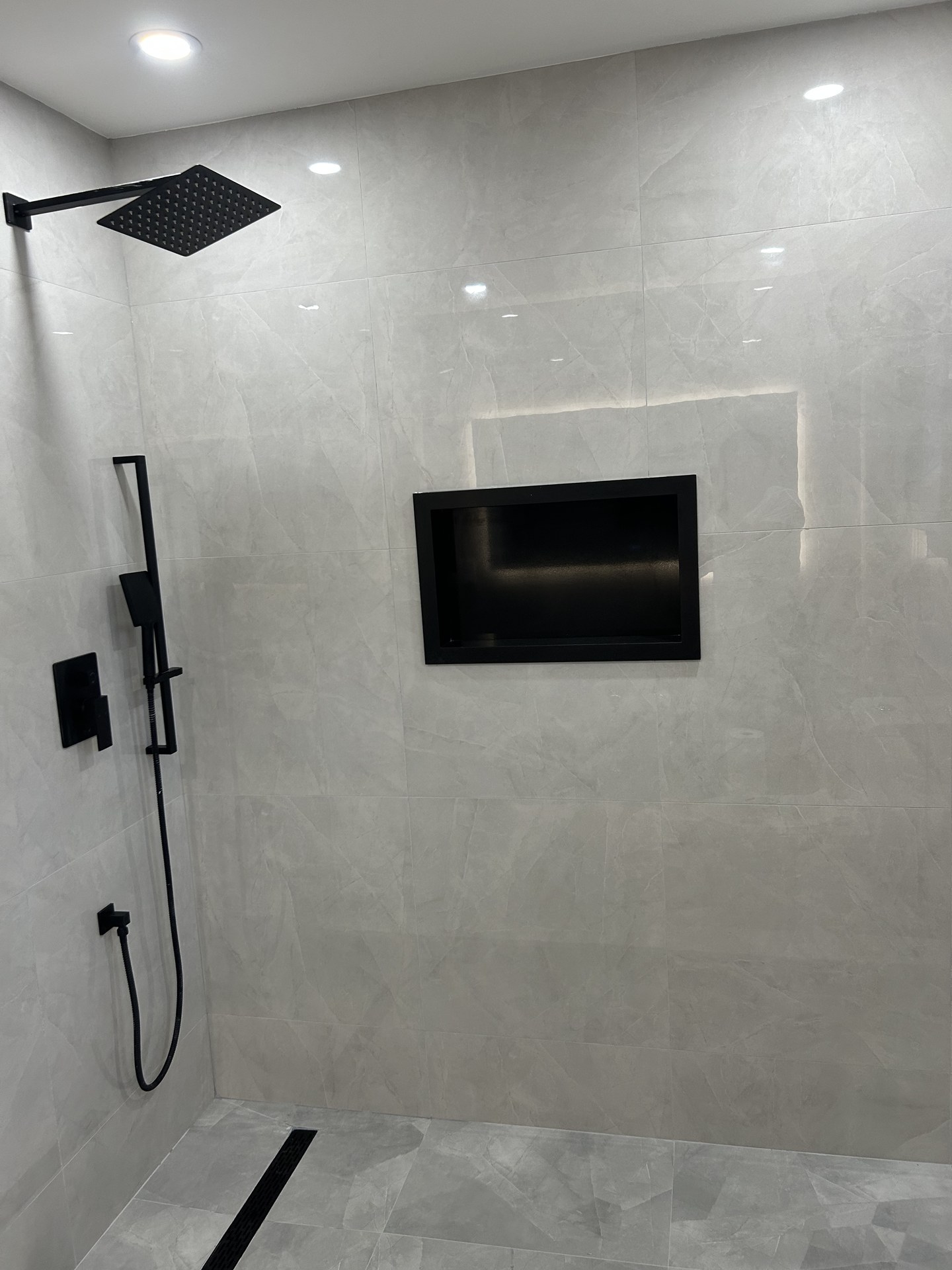 Frameless glass shower and porcelain tile work